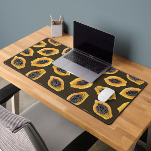 Papaya slices on dark brown desk mat