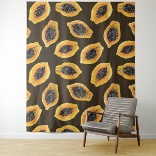 Papaya slices on dark brown tapestry