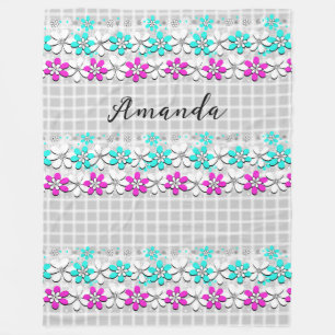 Paper neon flowers on a gray-white checkered  fleece blanket