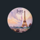Paris Eiffel Tower France Sunset Watercolor Travel Magnet<br><div class="desc">A luminous watercolor illustration of the Eiffel Tower in Paris, France, set against a radiant sunset sky with shades of lavender, blush, and gold. The scene captures the bridge over the Seine River, where gentle reflections of the tower and lamplights shine on the water’s surface. Architectural details and soft pastel...</div>