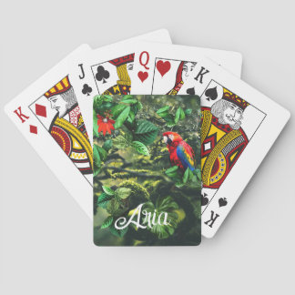 Parrot scarlet macaw in jungle with flowers playing cards