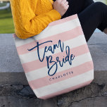 Pastel Coral Pink & White Stripes Blue Team Bride Tote Bag<br><div class="desc">All-Over-Print Tote bag featuring the words "Team Bride" in blue trendy script against a pastel coral pink and white stripes pattern background. Perfect for weddings for bridesmaids, maid of honour and flower girl. For other colours and matching items see here https://www.zazzle.com/collections/119250194970828530?rf=238364477188679314 Personalise it by replacing the placeholder text. For more...</div>