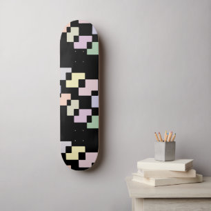 Pastel geometric blocks on black skateboard