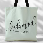 Pastel Mint Bridesmaid Modern Script Tote Bag<br><div class="desc">Show your appreciation to your bridal party with this stylish pastel mint green bridesmaid tote bag. Featuring modern script and customisable with your bridesmaid's name, this tote bag is both practical and elegant. The soft colour and chic design make it perfect for carrying wedding day essentials or everyday items. This...</div>