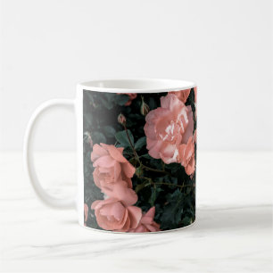 Pastel pink roses growing in the garden in soft li coffee mug