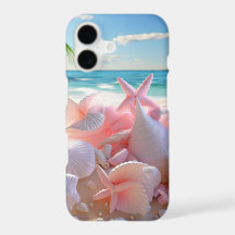 PASTEL PINK SEASHELLS ON A SANDY BEACH