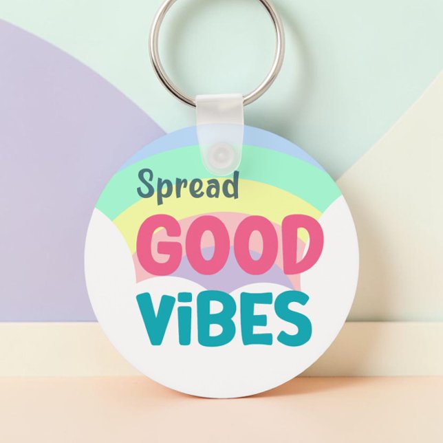 Pastel Rainbow Spread Good Vibes Quote Key Ring (Spread Good Vibes pastel rainbow keychain in a r ound chape against a pastel painted background.)