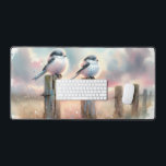 Pastel Watercolor Birds Fencepost Sunset Desk Mat<br><div class="desc">Soft watercolor brushwork captures two fluffy songbirds resting on weathered fence posts as a glowing sunset spreads across a dreamy countryside sky. Gentle washes of peach, blush pink, pale blue, and warm gold blend into a tranquil horizon, creating a calm pastoral atmosphere. The birds appear round and feathery, their delicate...</div>