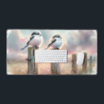 Pastel Watercolor Birds Fencepost Sunset Desk Mat<br><div class="desc">Soft watercolor brushwork captures two fluffy songbirds resting on weathered fence posts as a glowing sunset spreads across a dreamy countryside sky. Gentle washes of peach, blush pink, pale blue, and warm gold blend into a tranquil horizon, creating a calm pastoral atmosphere. The birds appear round and feathery, their delicate...</div>
