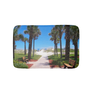Path to the beach and palm trees on a bath mat