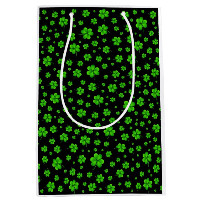 Pattern of green shamrocks on black background medium gift bag (Front)