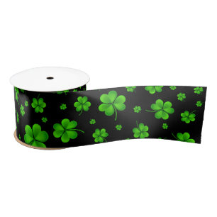 Pattern of green shamrocks on black background satin ribbon