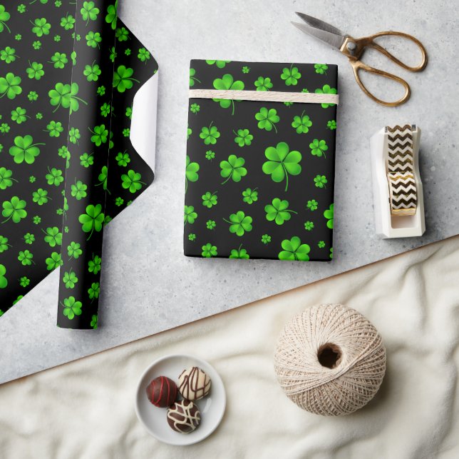 Pattern of green shamrocks on black background wrapping paper (Crafts)