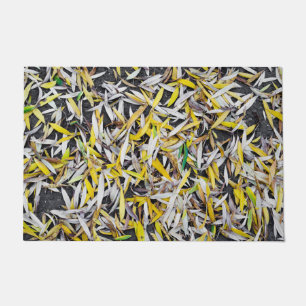 Pattern of the falling leaves on black doormat