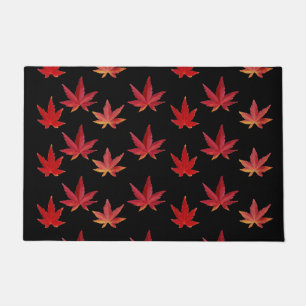 Pattern of the falling leaves on black doormat
