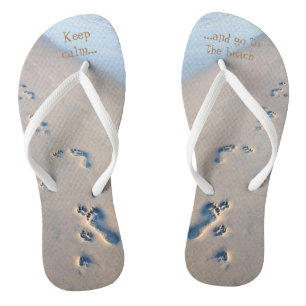 Paw prints and footprints in the sand jandals