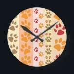 Paw Prints cute Dog Lovers Round Clock<br><div class="desc">Design with a cute pattern of dog paw prints in orange and yellow and warm colours. This design looks as though a dog has walked over the product ! For dog lovers everywhere.</div>
