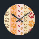 Paw Prints cute Dog Lovers Round Clock<br><div class="desc">Design with a cute pattern of dog paw prints in orange and yellow and warm colours. This design looks as though a dog has walked over the product ! For dog lovers everywhere.</div>