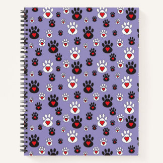 Paw prints with red hearts on blue notebook
