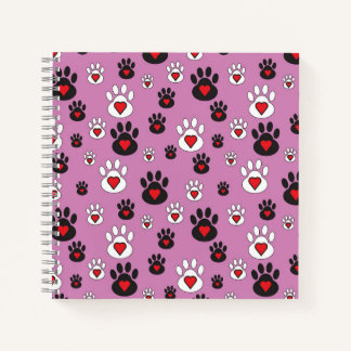 Paw prints with red hearts on pink notebook