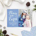 Peace on Earth Beautiful Script Blue Photo Holiday Card<br><div class="desc">Simply elegant "Peace on Earth" Christmas photo greeting card design features a minimal photo design with beautiful white script writing and a photo with custom "text that can be personalised. Peaceful blue background colour (can be customised) with subtle rustic textured appearance and modern geometric pattern on the back.</div>