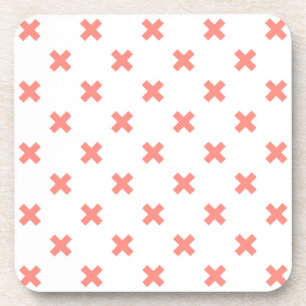 Peach cross stitches on white coaster
