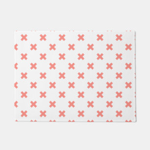 Peach cross stitches on white doormat