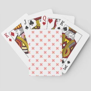 Peach cross stitches on white playing cards