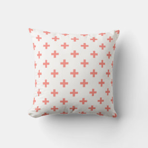 Peach polka crosses on white cushion