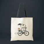 Peanuts | Snoopy & Woodstock Bicycle Tote Bag<br><div class="desc">Pedal into style and classic charm with this adorable cream canvas tote bag, featuring Snoopy and Woodstock on a bicycle! This fun tote showcases a delightful line-art illustration of Snoopy, wearing sunglasses, happily riding a vintage-style blue bicycle with Woodstock perched safely behind him. The dashed lines behind the back wheel...</div>
