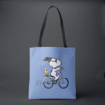 Peanuts | Snoopy & Woodstock Bicycle Tote Bag<br><div class="desc">Pedal into style and classic charm with this adorable cream canvas tote bag, featuring Snoopy and Woodstock on a bicycle! This fun tote showcases a delightful line-art illustration of Snoopy, wearing sunglasses, happily riding a vintage-style blue bicycle with Woodstock perched safely behind him. The dashed lines behind the back wheel...</div>
