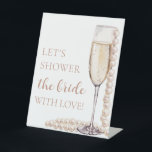 Pearls Prosecco Let's Shower The Bride With Love Pedestal Sign<br><div class="desc">The Pearls and Prosecco Let's Shower the Bride With Love sign is a charming addition to your bridal shower decor. Featuring elegant pearls and prosecco motifs, this sign sets the tone for a celebration filled with love and joy. Display it prominently to welcome guests and encourage them to participate in...</div>