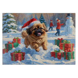 Pekingese Dog Running in Snow with Christmas Hat Cutting Board