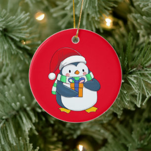 Penguin in a Christmas hat with a gift Ceramic Tree Decoration