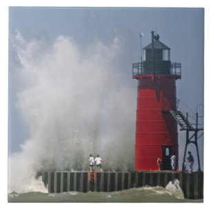 People on jetty watch large breaking waves in 2 tile