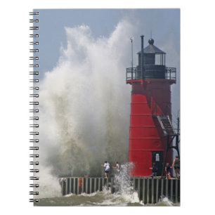 People on jetty watch large breaking waves in spiral notebook