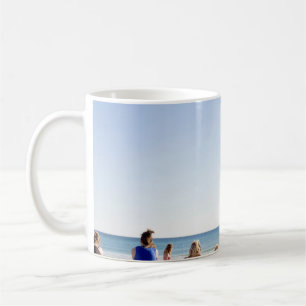 People on white sands by the beach coffee mug