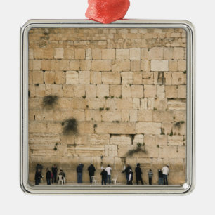 People praying at the wailing wall metal tree decoration
