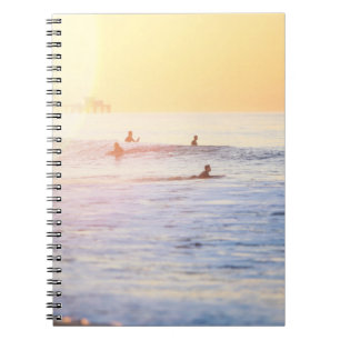 People surfing on beach notebook