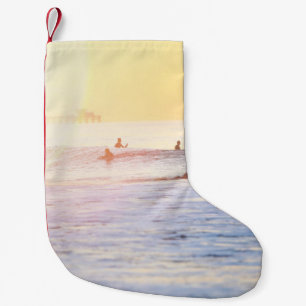People surfing on beach small christmas stocking