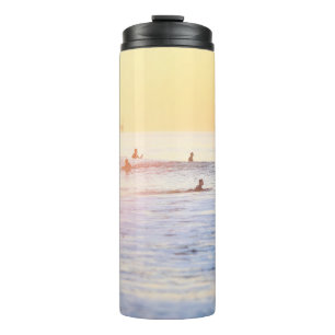 People surfing on beach thermal tumbler