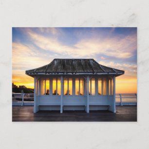 People watching sunset on Cromer pier in Norfolk Postcard