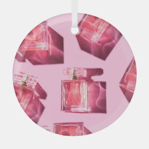 Perfume bottles, pink background, flatlay glass tree decoration