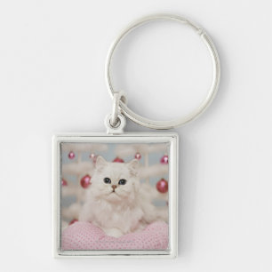 Persian cat sitting on pink pillow key ring