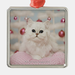 Persian cat sitting on pink pillow metal tree decoration