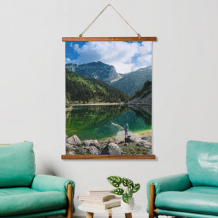 Person at mountain lake hanging tapestry
