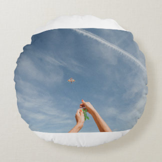 Person flying kite in the morning round cushion