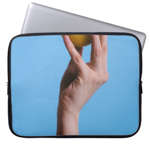 Person holding lemon laptop sleeve