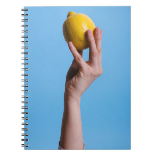 Person holding lemon notebook