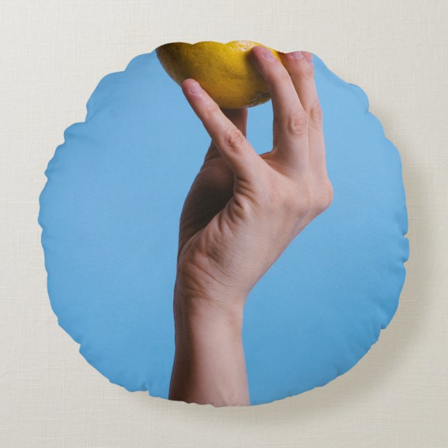Person holding lemon round cushion (Front)